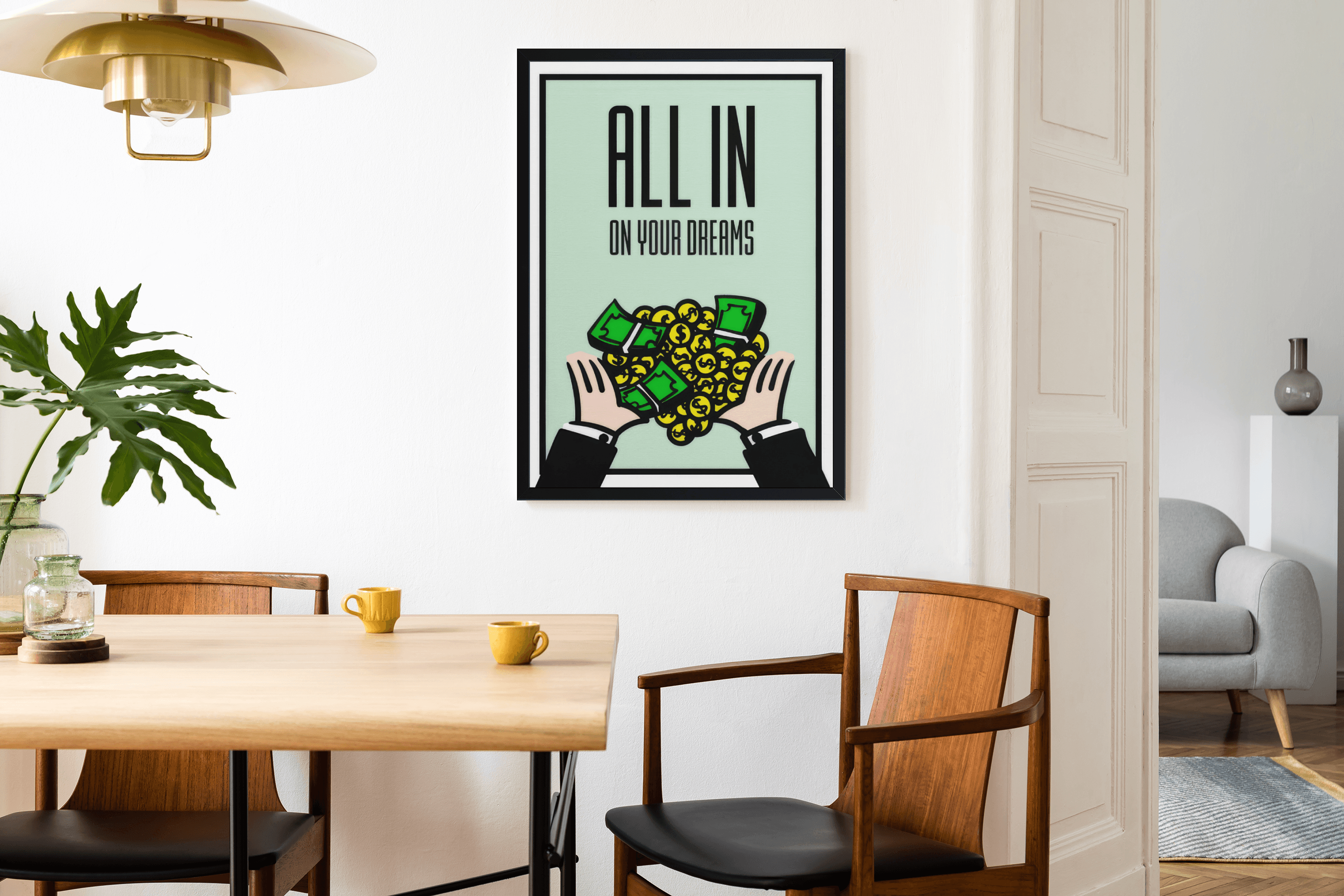 Black framed All In On Your Dreams print on a white dining room wall with oak table