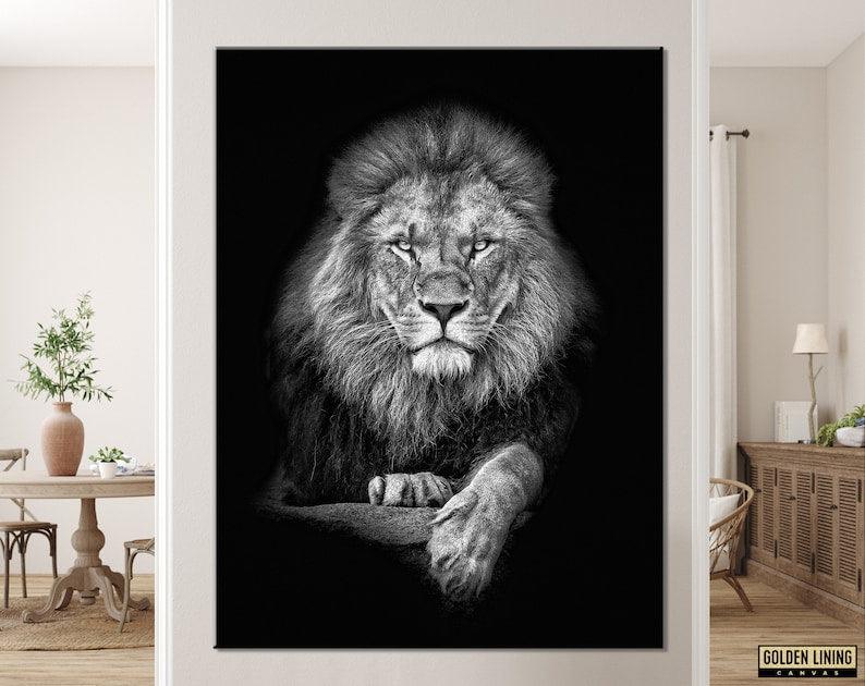 Black and white lion portrait canvas hanging on a pale wall above a rustic dining table