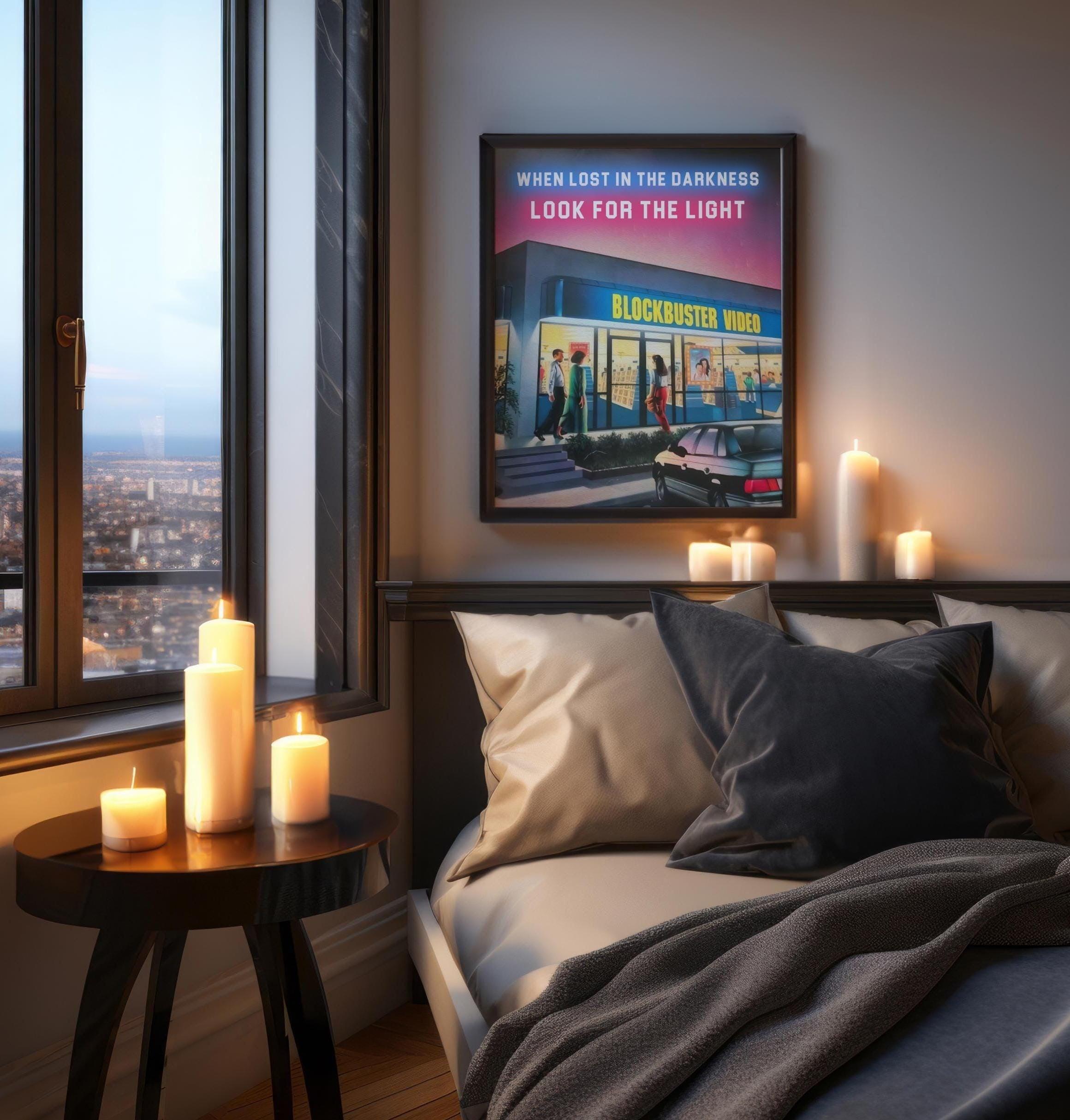 Dark framed retro video store poster above a bed, warm candles glowing on the ledge