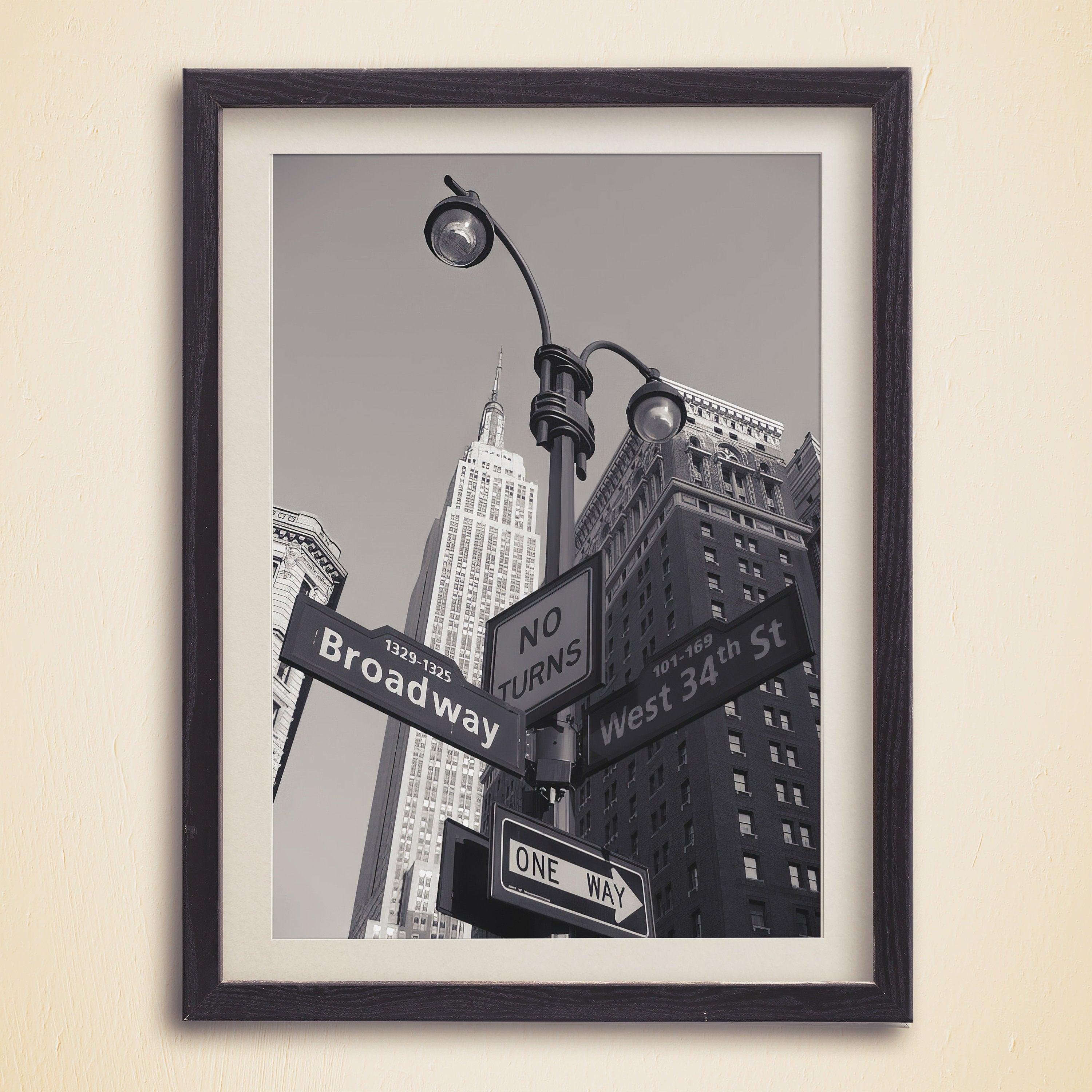 Broadway and West 34th St street signs with One Way arrow and Empire State Building, dark framed print