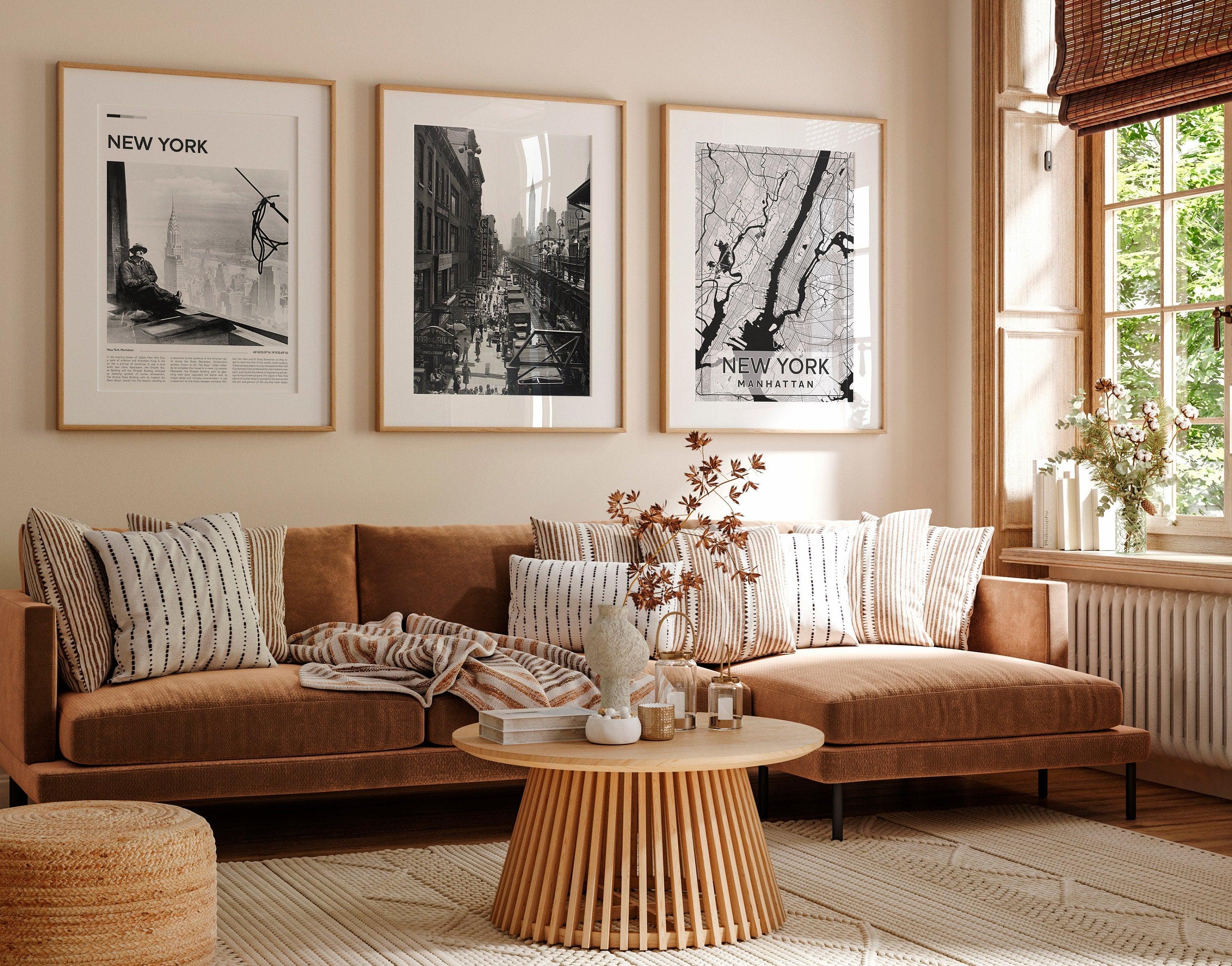 Manhattan map and vintage New York prints hung over a tan velvet boho sofa