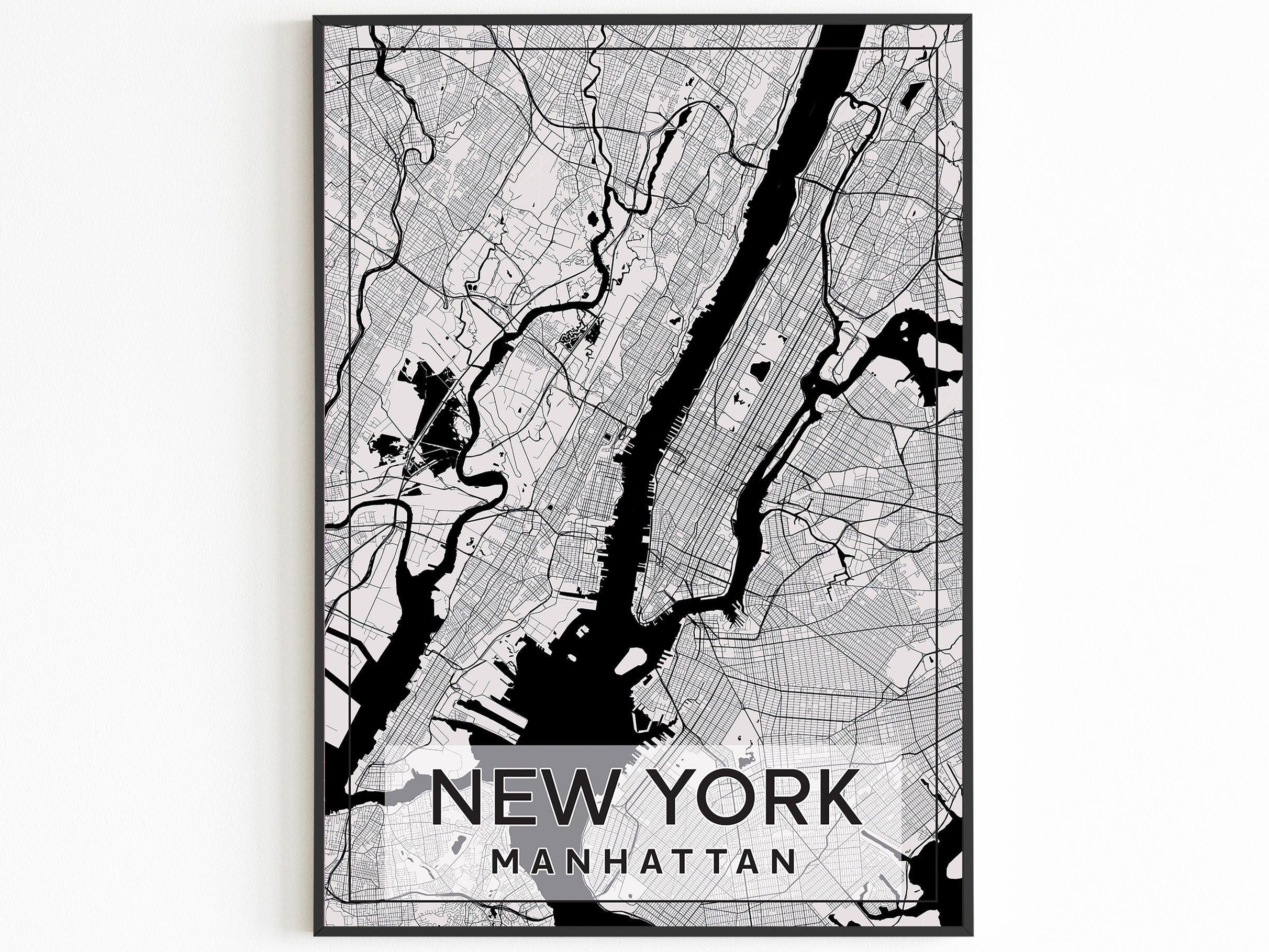 Black framed Manhattan street map poster reading New York Manhattan on a white wall