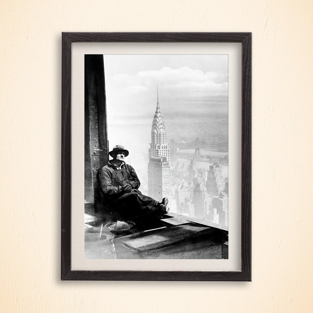Construction worker resting on a steel beam above the Chrysler Building and Manhattan skyline, framed print