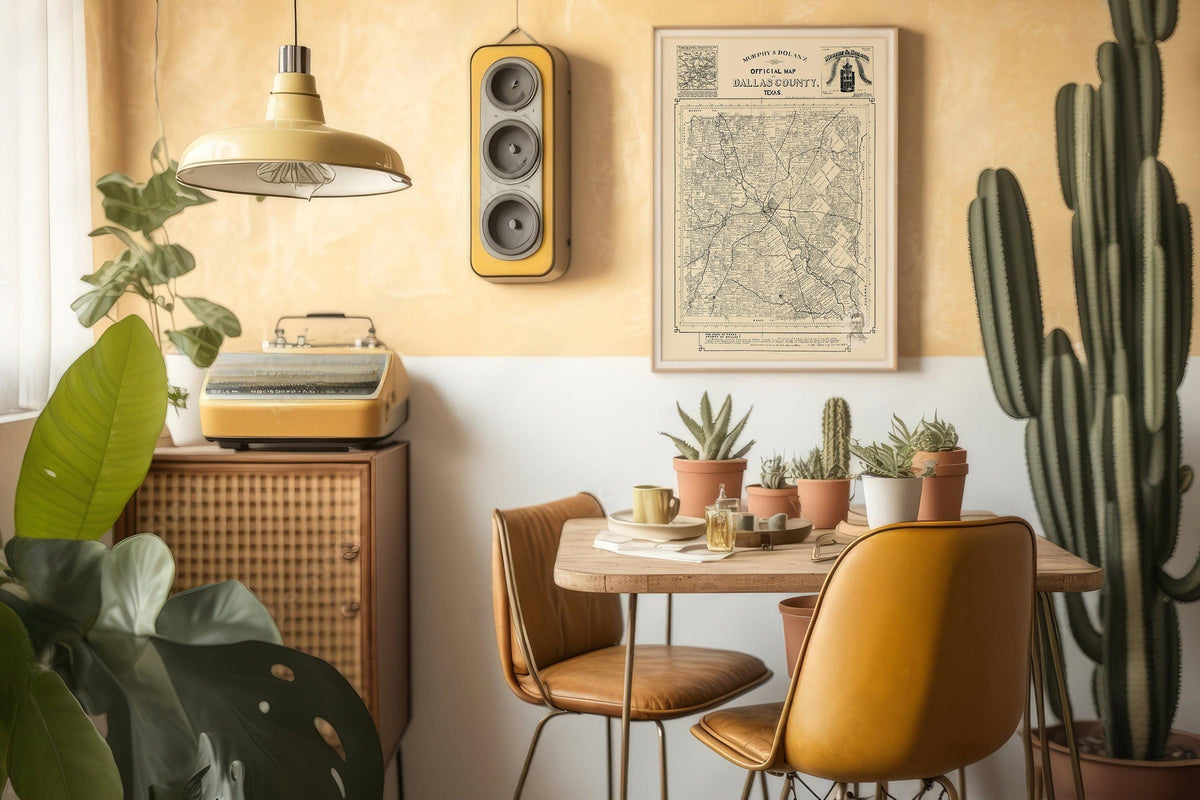 Old Dallas County survey map in a light wood frame on a warm ochre wall above a cactus filled dining nook