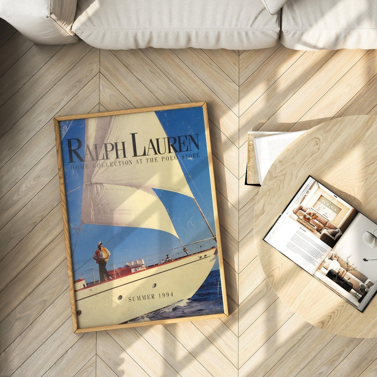 Framed nautical yacht print resting on herringbone wood floor beside magazine, Summer 1994 cover art